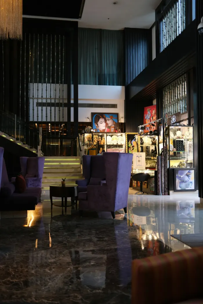 Hotel lobby lounge with seating and a reception staircase